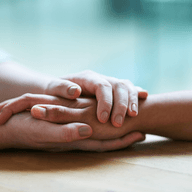 two hands holding giving mental support