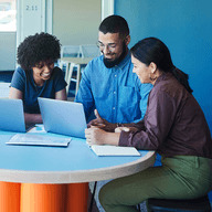 three people working together