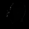 A lightened face on darkness