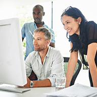 three people working together