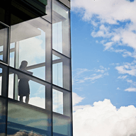 girl looking at a window in a big building