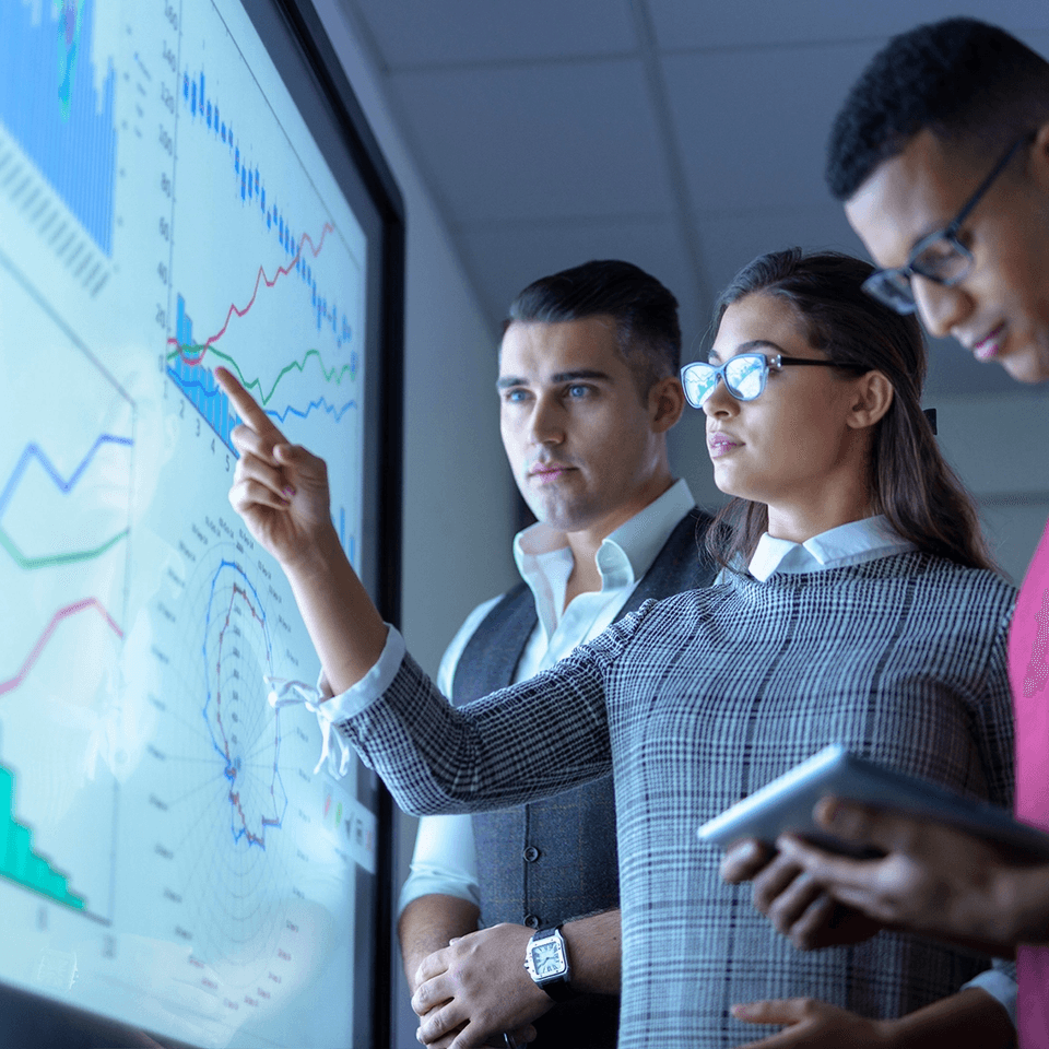 business team viewing charts and graphs on interactive-screen