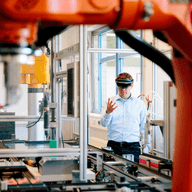 Man in factory with robots