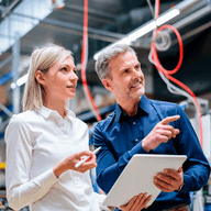 Two people talking in a factory