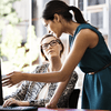 Two women collaborating at computer.