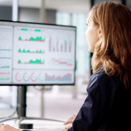 Woman analyzing charts on computer