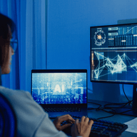 Woman analyzing AI data on screens.