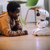 Child interacting with small white robot.