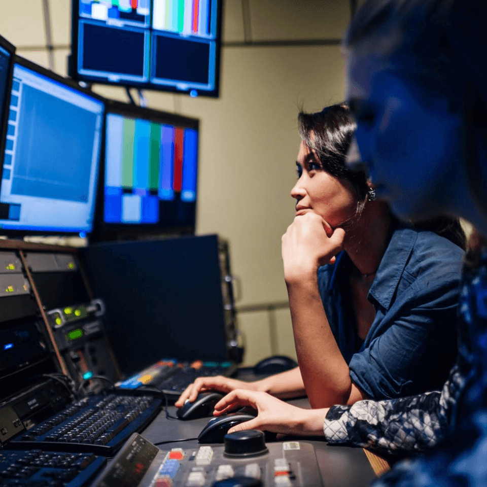 Two people working in control room