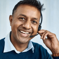 A smiling man with headphones on