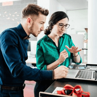 Man and a woman looking at a laptop