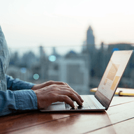 Hands working on a laptop