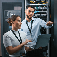 two workers in a server room