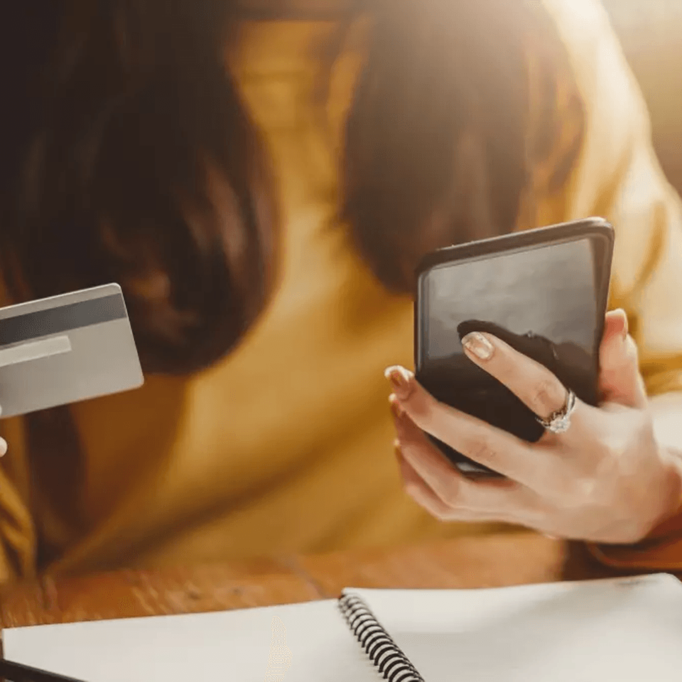young-beautiful-asian-woman-using-smart-phone-and-credit-card