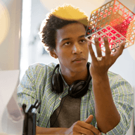 young man holding a cube