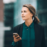 woman holding her mobile outside