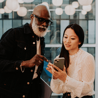 two people looking at a phone